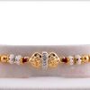 Exclusive Golden OM Rakhi with Pearl Rings 4