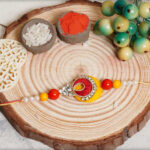 Beautiful Pearls Traditional Rakhi With Mauli Thread