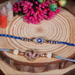 Premium Evil Eye Bhaiya Rakhi with Pastel Pink Bhabhi Rakhi