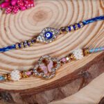 Premium Evil Eye Bhaiya Rakhi with Pastel Pink Bhabhi Rakhi